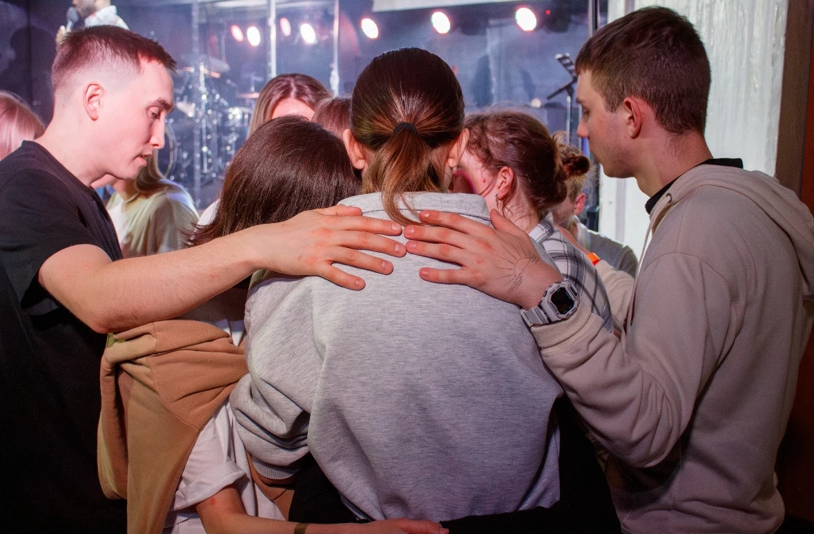 A group gathered around an open Bible